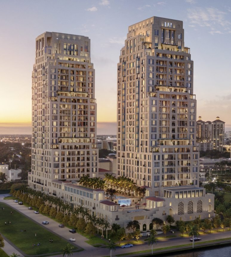 A rendering of twin residential towers at dusk above a palm lined waterfront